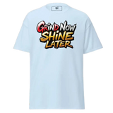 Light blue t-shirt with ’Grind Now Shine Later’ graphic.