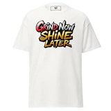 White t-shirt with ’Grind Now Shine Later’ graphic.