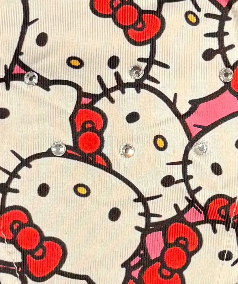 Hello kitty fabric with rhinestones and red bows.