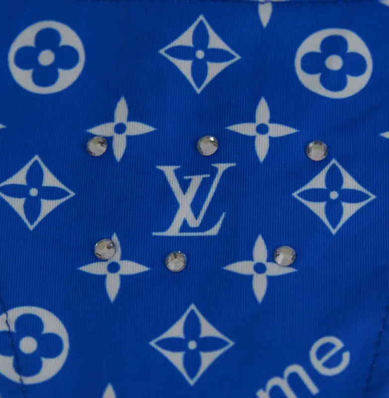 Blue fabric with white floral and diamond patterns, embellished with rhinestones.