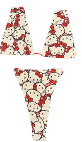 Hello kitty patterned leggings with red bows and white background.