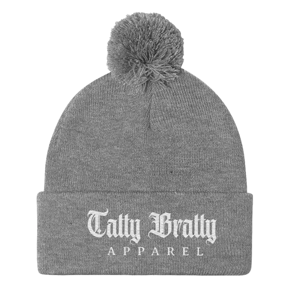 Gray knit beanie with pompom.