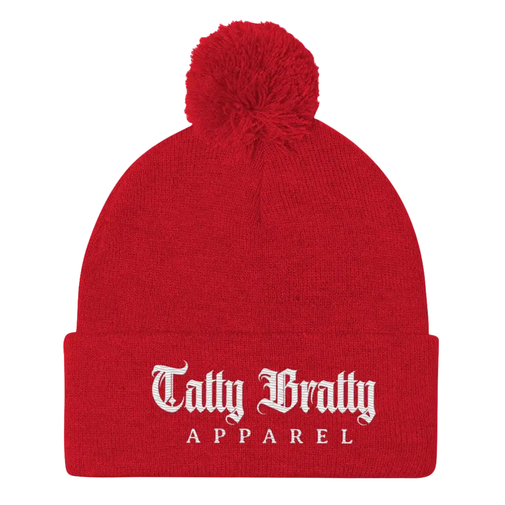 Red knit beanie with pompom.