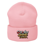 Pink beanie with embroidered text.