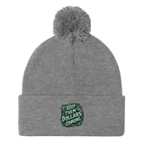 Gray knit beanie with pompom.